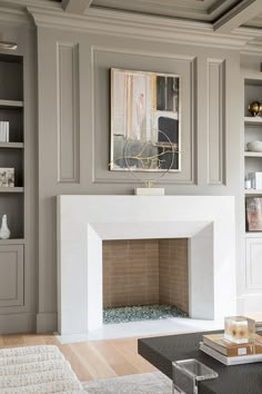 a living room filled with furniture and a fire place in front of a book shelf