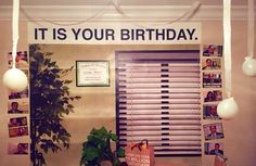 there is a sign that says it is your birthday hanging on the wall in this office