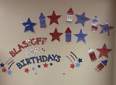 a bulletin board with red, white and blue stars on it that says blast off for birthdays