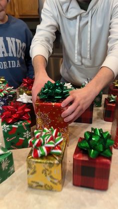 a man is wrapping presents on the table