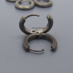 Men's medium sized huggie hoop earrings in 9mm. These hoop earrings have a slight dome design and flat edges. Sold as a pair or single earring. SPECIFICATION Base metal: Recyclable fine 925 Sterling Silver Outer layer : Black plating, matte finish Outer Diameter: 13mm Inner Diameter: 9mm, size M Width: 2.5mm Ear Post Gauge: 20G Measurements are an approximation. Available in polished white https://www.etsy.com/listing/250896161 Thank you for your interest in our domed hoop earrings for men. Adjustable Small Hoop Earrings, Small Metal Hoop Earrings, Hypoallergenic Metal Hoop Earrings, Mens Hoop Earrings, Earrings Mens, Men's Earrings, Tragus Hoop, Mens Earrings Hoop, Men Earrings