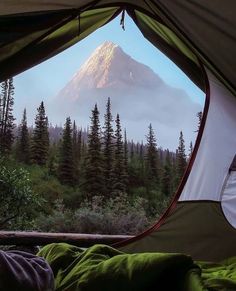 a view of a mountain through a tent