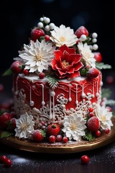 a red cake decorated with flowers and berries