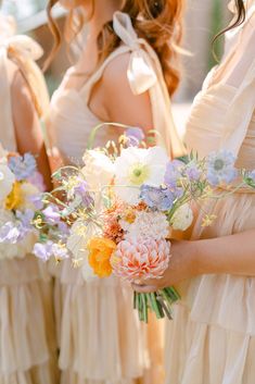 the bridesmaids are holding bouquets of flowers