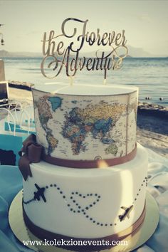 a wedding cake with a world map on top and the words, the forever adventure