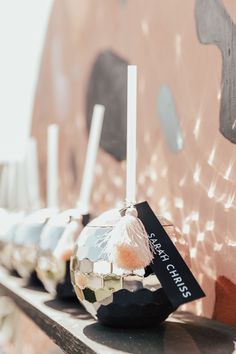 a row of candles sitting on top of a wooden shelf