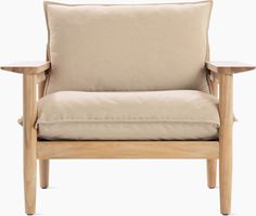 a wooden chair with a beige pillow on it's back and armrests