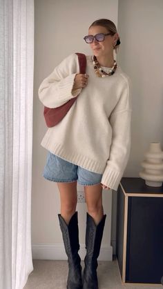 Denim shorts, cowboy boots, sweater Knee High Boots Fall 2024, Winter Boots Dress Outfit, Boot Inspo Outfit, Fall Outfits With Western Boots, Shorts And Long Boots Outfits, Cowboy Boots Outfit Nyc, Frye Boots Fall Outfit, Harness Boots Womens Outfits, Long Shorts And Boots Outfits