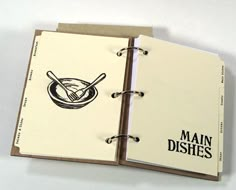 an open recipe book with the words main dishes written in black and white on it