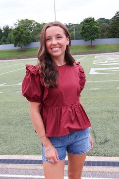 Elevate your wardrobe with our Maroon Peplum Ruffle Top! Made from high-quality poplin cotton, this top features puff sleeves and feminine ruffle details. With ties at each side, it offers a perfect fit. Whether for pre-fall or gameday, it's a must-have addition to your collection! Maroon peplum ruffle top Poplin cotton Puff sleeves Peplum hem Side ties Gameday top Maroon gameday top Cheap Fitted Peplum Top With Ruffle Hem, Peplum Crop Top, Gameday Outfit, Peplum Hem, Peasant Top, Short Leggings, Peasant Tops, Ruffle Top, Shop Swimwear