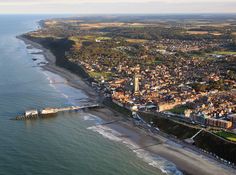 an aerial view of a city next to the ocean