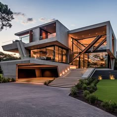 a large modern house with stairs leading up to the upper floor and second story area