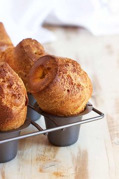 three buns sitting on top of each other in pans