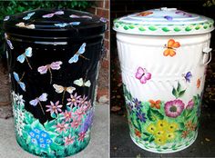 two trash cans painted with flowers and butterflies on them, one is black and the other is white