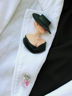 Elegant woman in black titfer hat. The brooch made of polymer clay. There are 3 ruby stones in a perfume bottle. This is my second C*co style brooch. Always stay beautiful and charming in your favorite clothes! Chic Evening Jewelry Brooch, Chic Evening Brooch Jewelry, Chic Brooch Jewelry For Parties, Chic Party Brooch Jewelry, Classic Evening Brooch, Elegant Collectible Lapel Pin, Black Brooch Lapel Pin As Gift, Black Lapel Pin Brooch As Gift, Black Lapel Pin Brooch For Gift