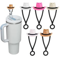 four different colored hats are attached to the handle of a coffee cup holder with handles