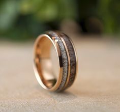 a wedding band with two wood inlays