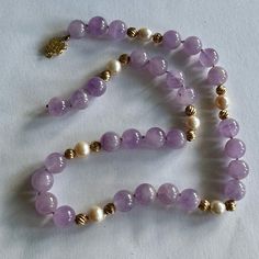 This Natural Amethyst Beaded Necklace Is 18” Long & Knotted Between Each Bead. The Amethyst Beads Are 10mm. The Pearls Are 7.5mm And The 14k Gold Fluted Beads Are 5mm. The 14k Gold Clasp Is A Round Filigree Shape With An Asian Character On It. It Also Has An Extra Safety Latch. One Side Of The Strand Is Broken From The Clasp, No Beads Are Missing, But It Needs To Be Repaired. Elegant Lavender Beaded Necklace With Natural Stones, Classic Amethyst Purple Necklace, Classic Purple Amethyst Necklace, Elegant Lavender Necklaces With Gemstone Beads, Elegant Lavender Beaded Necklace With Gemstones, Purple Hand-strung Necklaces, Elegant Single Strand Amethyst Beaded Necklace, Classic Purple Round Bead Jewelry, Purple Round Bead Necklace For Formal Occasions