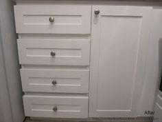 a white cabinet with knobs and drawers in a bathroom