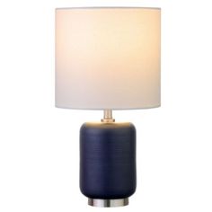 Bring a touch of retro styling to your bedside, mantle, or hall table with this textural mini accent lamp. The jar-shaped base is made of lightly ribbed ceramic, creating an organic feel to the fixture. Accented with a metal standing ring and a crisp linen shade, this lamp is the perfect piece anywhere you need to shed a little extra light. | Hinkley & Carter Lambert Mini Lamp Blue Lamps, Family Room Lighting, Mini Table Lamps, Fixture Table, Mini Lamp, Outdoor Light Fixtures, Kitchen Pendants, Hall Table, Black Table Lamps