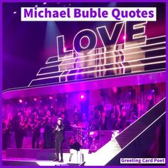 michael buble quotes love on stage in front of an audience at a concert with purple lighting