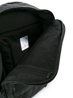 the back compartment of a black backpack on a white background