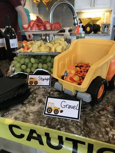 a table topped with lots of fruits and vegetables next to a sign that says gravel