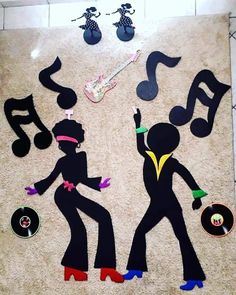 an art project with musical instruments and silhouettes made out of paper on the floor