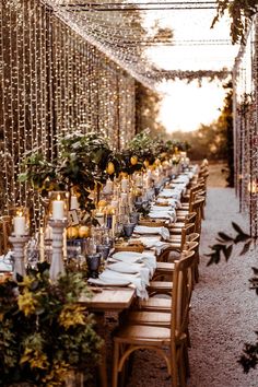 a long table is set with place settings and candles