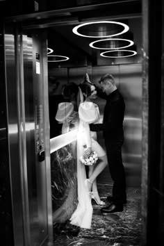 a man and woman standing in an elevator