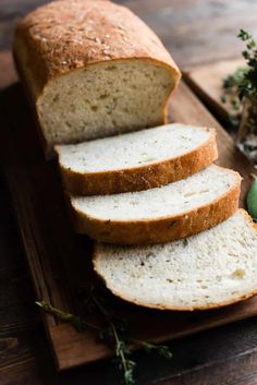 sliced loaf of bread sitting on top of a cutting board