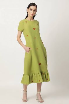 Grass green midi dress with heart embroidered motifs and frilled hem.
Components: 1
Pattern: Embroidery
Type Of Work: Heart Motifs
Neckline: Round
Sleeve Type: Short
Fabric: Cotton Linen, Voile
Color: Green
Other Details: 
Brown colored embroidery
Side pockets
Disclaimer: The embroidery motif placement may vary from piece to piece since it has been placed randomly.
Occasion: Work - Aza Fashions Green Spring Dress With Embroidered Hem, Spring Green Dresses With Embroidered Hem, Casual Green Dresses With Embroidered Hem, Green Midi Dress With Ruffle Hem, Green Short Sleeve Dress With Embroidered Hem, Cotton Summer Dress With Tonal Embroidery, Green Embroidered Cotton Dress For Summer, Green Short Sleeve Dress With Ruffle Hem, Green Cotton Midi Dress With Ruffles