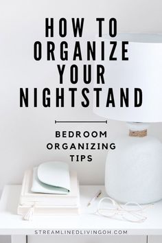 a white lamp sitting on top of a table next to some books and papers with the words how to organize your nightstand