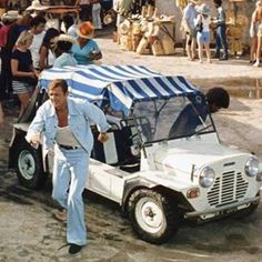 a man walking next to a white jeep