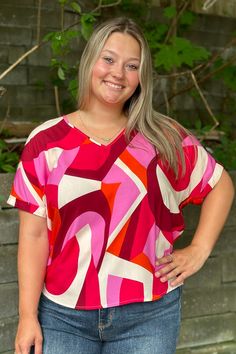 A fun and loose fit blouse with a bright color pattern and a geometric print design. There are short sleeves with a rolled fabric, and a v neckline. It is lightweight and would be fun to pair with linen pants and sandals for a lunch date. Jessica is 5'7" and wearing her true size Large. Small: Bust 23", Length 26" 100% Rayon Loose Fit Blouse, Lunch Date, Geo Print, Denim Jumpsuit, Bottom Clothes, Cardigan Tops, Linen Pants, Bright Color, Small Bust