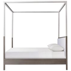 a white bed with a metal frame and pillows on it's sides, against a white background