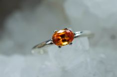 This is an absolutely stunning Spessartite Garnet from Tanzania set in Sterling Silver! This stone has an amazing brilliance and luster with great clarity and rare natural bright orange color! Spessartite Garnets are one of the more rare and valuable stones of the Garnet family, you will not be disappointed with this stone! Garnet is January's Birthstone. This perfect sized 6mm X 4.5mm oval cut Spessartite Garnet weighs 0.660 cts and will go with any style or occasion and will be sure to make pe Oval Orange Topaz Gemstone Ring, Classic Orange Topaz Ring For Gift, Classic Orange Topaz Ring Gift, Classic Orange Topaz Ring As Gift, Gift Orange Topaz Gemstone Ring, Spessartite Garnet, Gem Ring, Garnet Rings, Bright Orange