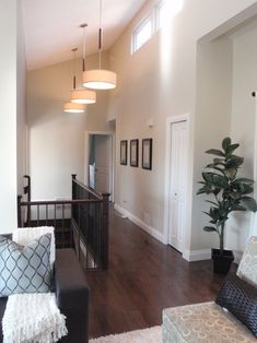 a living room with hard wood floors and white walls