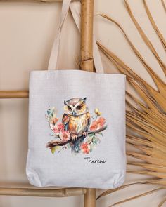 an owl is sitting on a branch with flowers