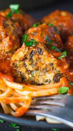 spaghetti and meatballs on a plate with tomato sauce