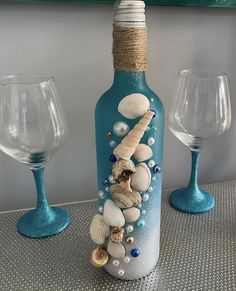 a bottle with shells and pearls on it