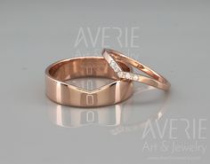 two gold wedding bands with diamonds on them