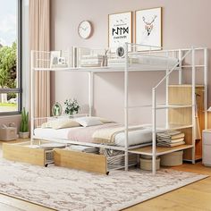 a white bunk bed sitting on top of a hard wood floor next to a window