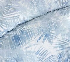 a blue and white palm leaf print bedding set with matching comforter coverlet