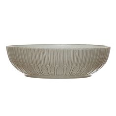 a white bowl with wavy lines on the rim and bottom, sitting in front of a white background