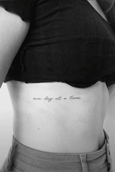 the back of a woman's stomach with an inscription on it that reads, one day at a time