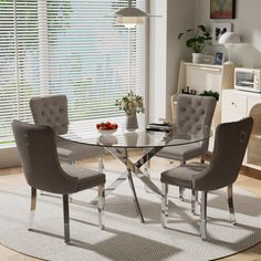 a glass table with chairs around it in front of a white rug and window blinds