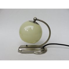 an apple lamp sitting on top of a metal stand