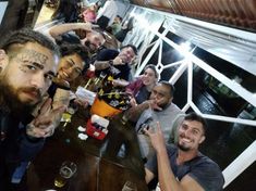 a group of people sitting around a wooden table