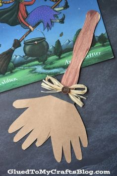 an image of a hand holding a book with the title, witch's broom